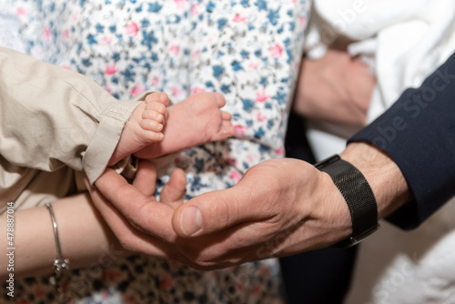 Baptism of a baby, close up of tiny baby feet, sacrament of baptism.