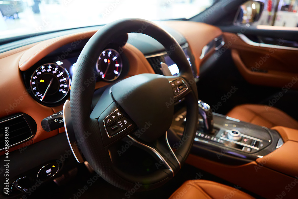 Car inside driver place. Interior of prestige modern car. Steering wheel, dashboard, display. Luxury car interior