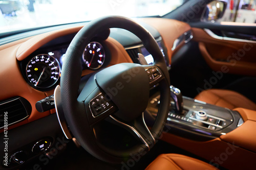 Car inside driver place. Interior of prestige modern car. Steering wheel, dashboard, display. Luxury car interior