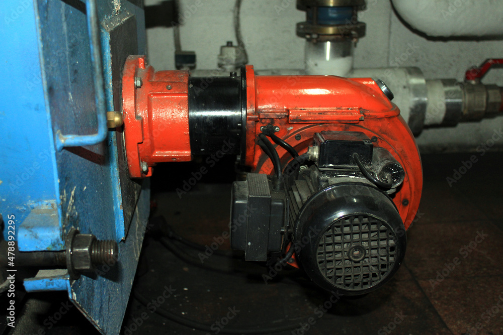 Old gas-oil burner in a boiler room 