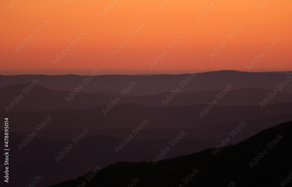 Foggy mountains silhouettes at morning sunrise Foggy mountains silhouettes at morning sunrise