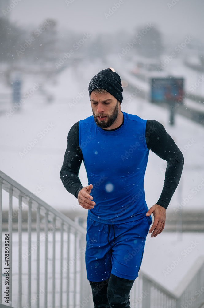 Man running outside on a cold winter day. Man running outside on a cold winter day.