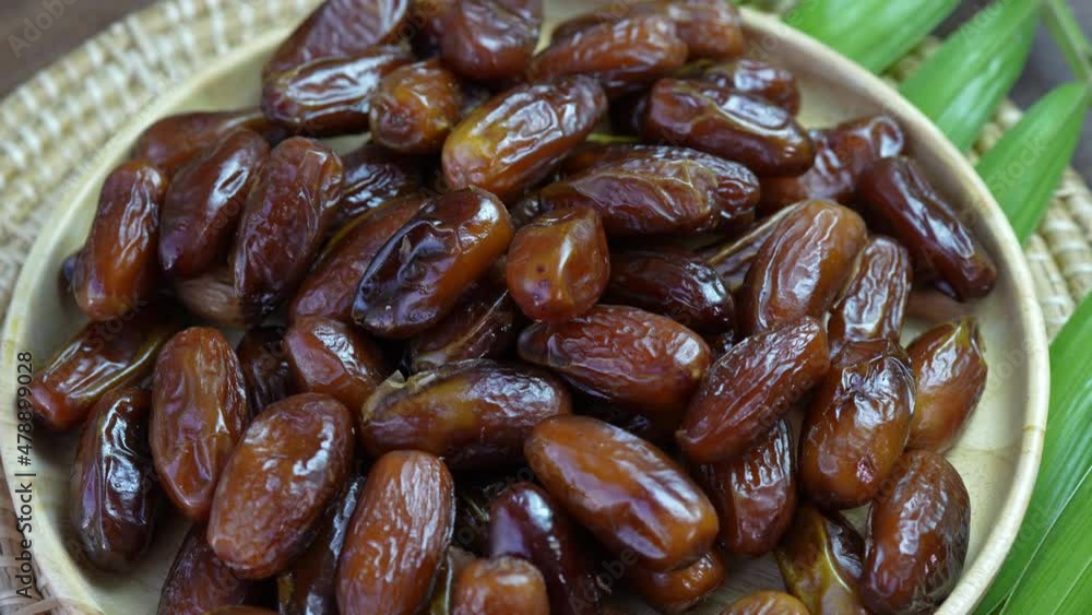 Dried  date palm fruit on a wooden plate, Sweet date palm fruit.  