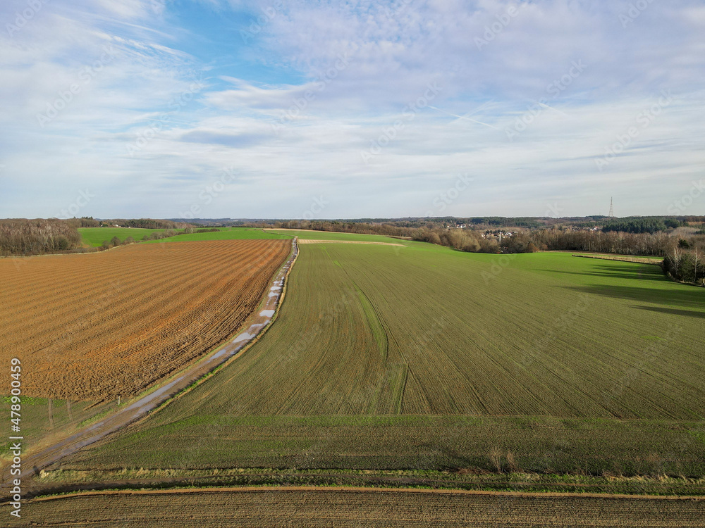 Areal view of agricultural field against cloudy sky in south of Belgium.