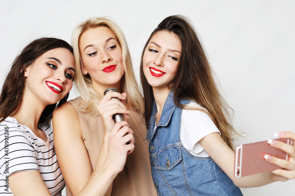 beauty girls with a microphone singing and having fun together beauty girls with a microphone singing and having fun together
