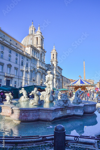 Fontana del Moro (Moor Fountain) at the Piazza Navona and a Christmas market in Rome, Italy. It represents a Moor, or African, perhaps originally meant to be Neptune