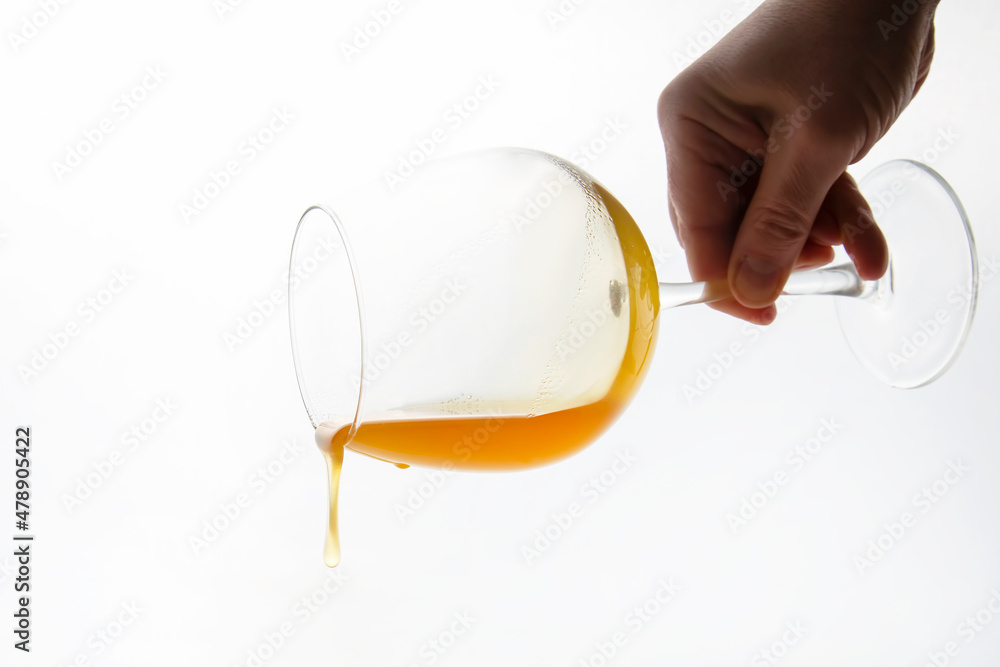 honey flowing from a wine glass on a white background. vitamin organic food honey flowing from a wine glass on a white background. vitamin organic food
