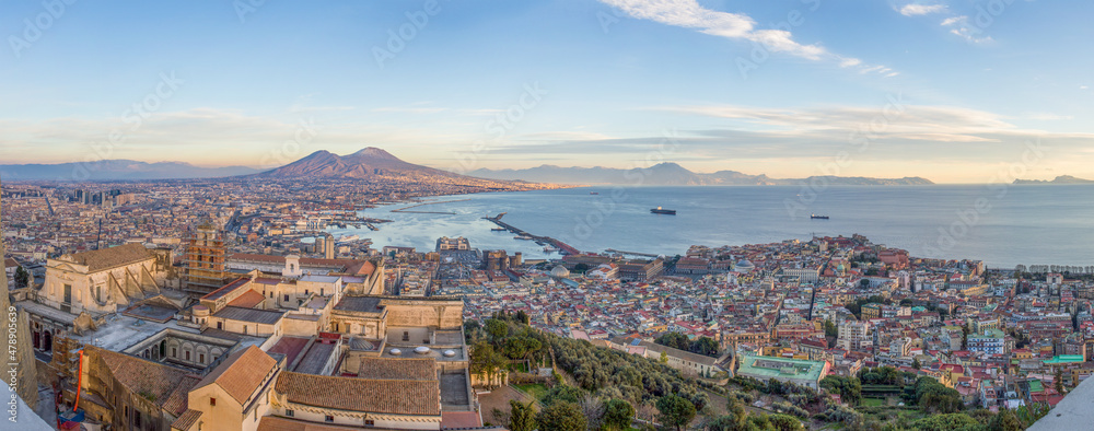 Wide angle view of City of Naples, mount Vesuvius and Gulf of Naples from the top of San Elmo Castle in the evening