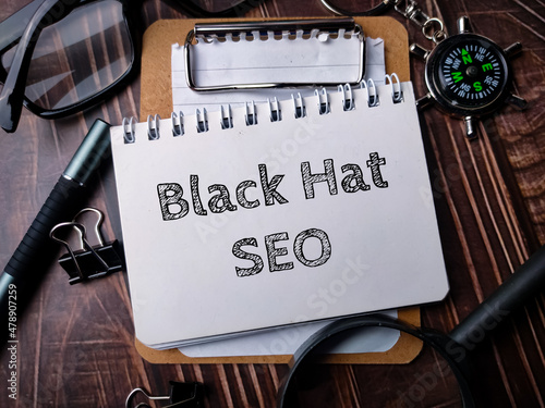 Notebook with Toolls and text Black Hat SEO. photo