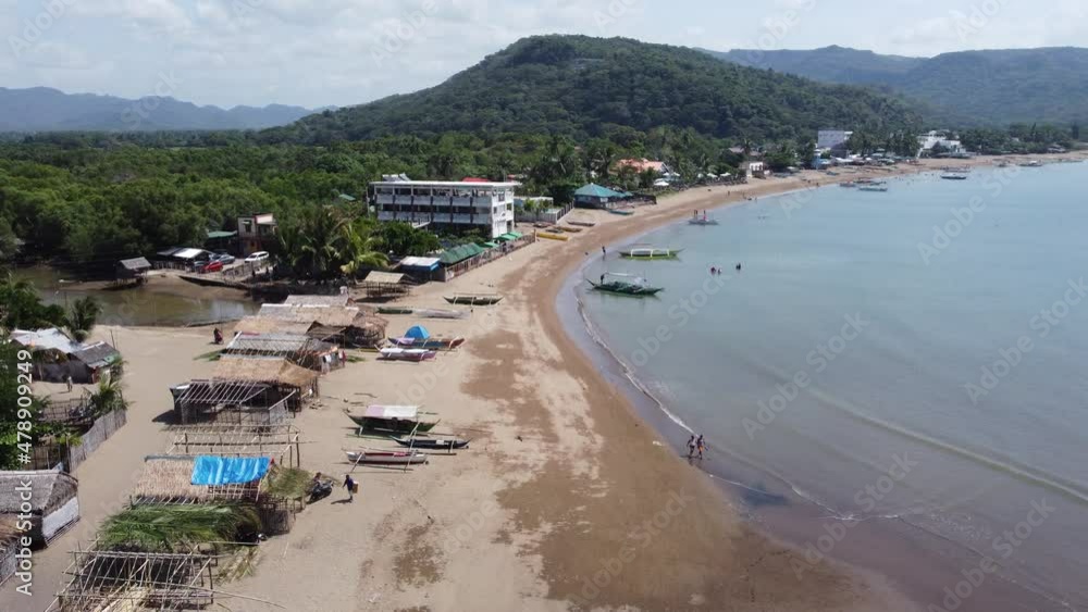 Drone flying over a beach approaching a small hill in Batangas, Philippines Drone flying over a beach approaching a small hill in Batangas, Philippines