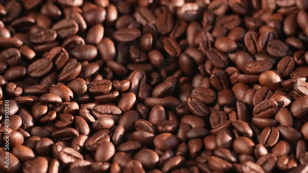 Close up of seeds of coffee. Fragrant coffee beans are rotate Close up of seeds of coffee. Fragrant coffee beans are rotate
