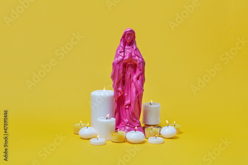 Virgin Mary statue with candles photo