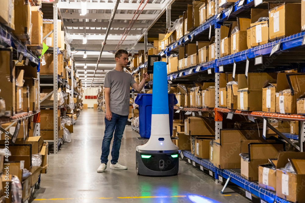 Robot and manager at Warehouse aisle Distribution Robot and manager at Warehouse aisle Distribution