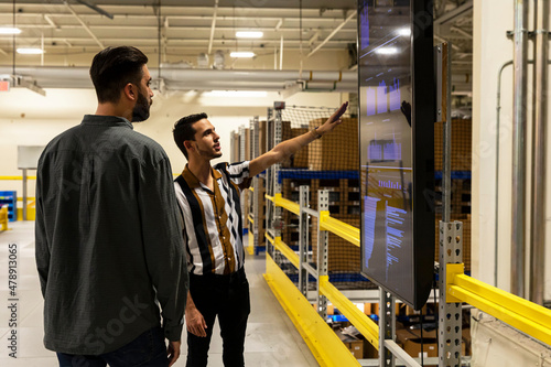 Manager meets with worker at E-Commerce Warehouse  photo