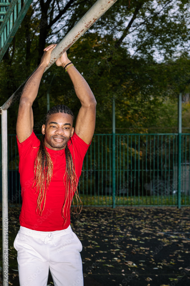 Black man doing exercise in a sport field Black man doing exercise in a sport field