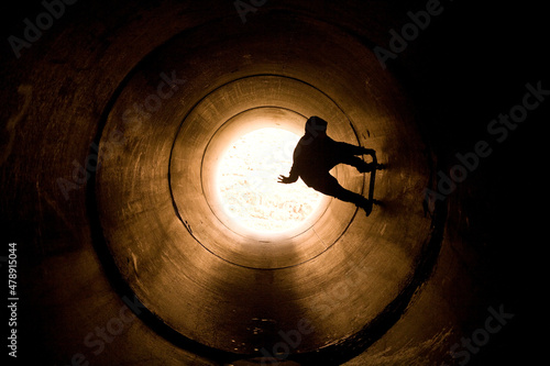 skateboarder skating in  a fullpipe photo
