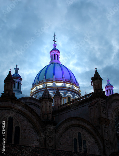 Cathedral of the Immaculate Conception in the historic center Cuenca, Ecuador. Historic church in the evening, beautiful dome with a dramatic sky. Ecuado´s travel destinations. Architectural heritage. photo