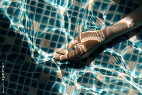 elegant female hand underwater photo