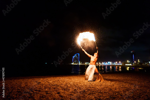 tribal latino man conducts a fire show photo