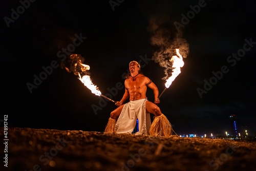 tribal shaman doing fireshow photo