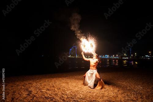 male performer breathing with fire photo