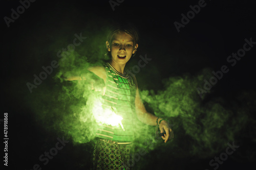 A girl plays with a sparkler photo