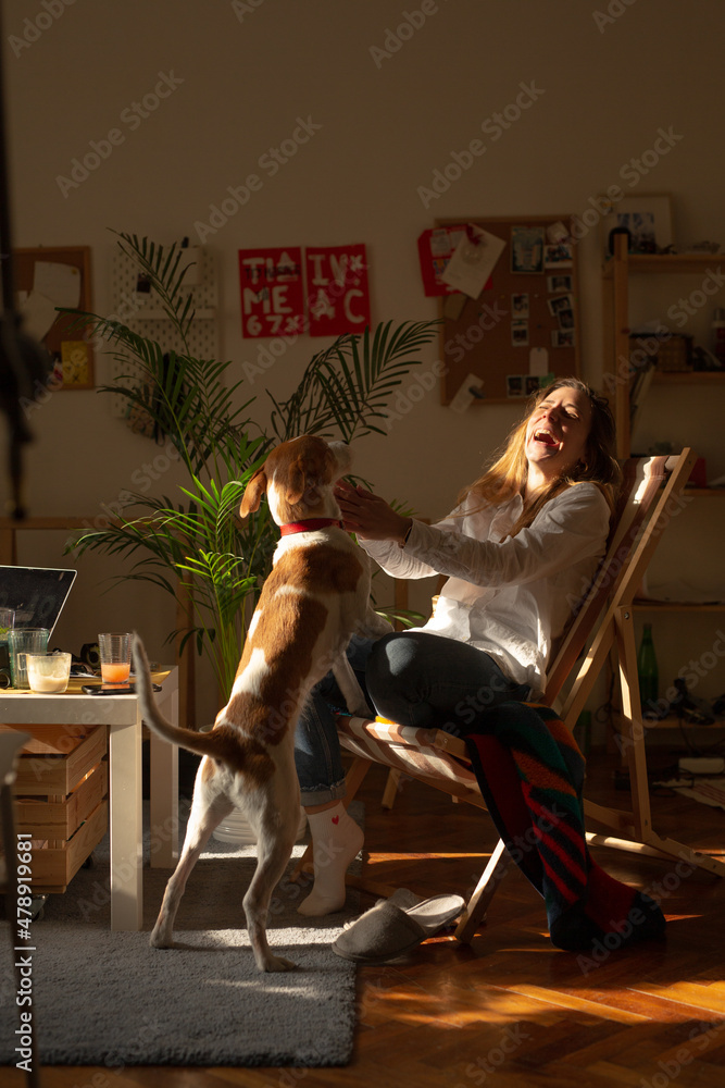 Smiling Woman Playing With Her Dog