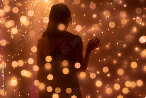 Silhouette of  woman surrounded by lights photo