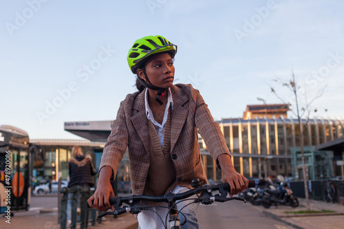 young black woman riding a bike, city bicycle commute photo