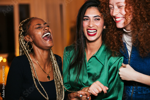 Stylish diverse women laughing at joke