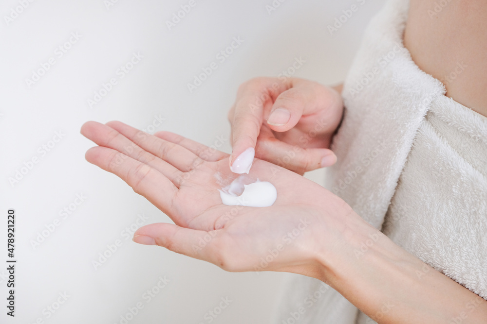 Woman applying natural cream, Woman moisturizing her hand with cosmetic cream, Spa and Manicure concept.