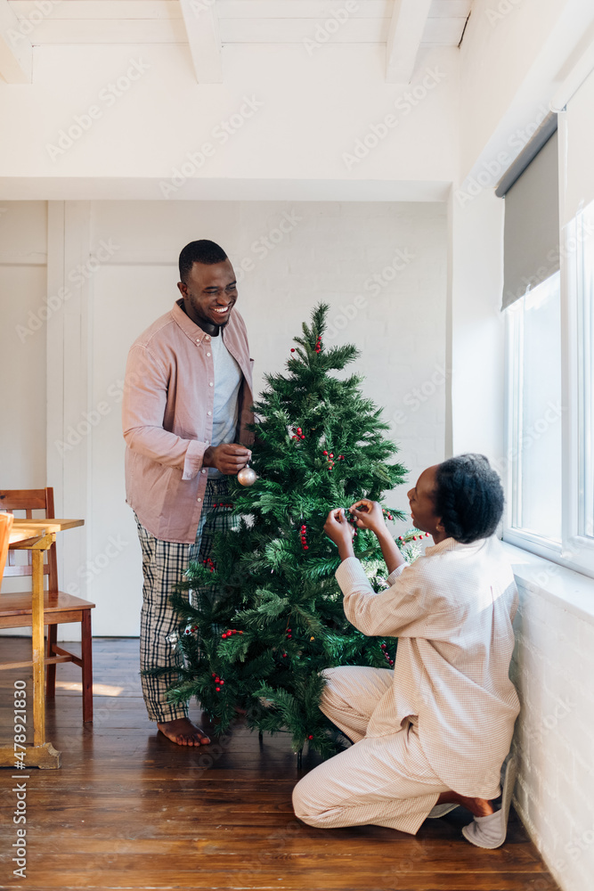 Couple Decorating Christmas Tree Couple Decorating Christmas Tree