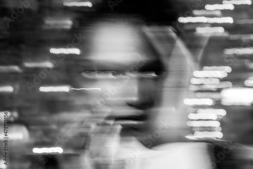 night woman portrait looking at camera, motion blur photo