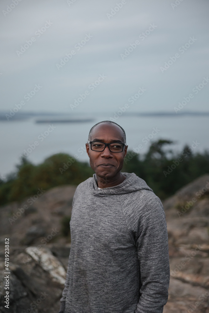 Man looking around on a hill at sunset
Man looking around on a hill at sunset