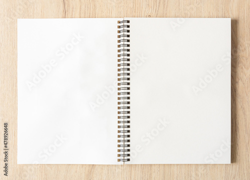Bilde på lerret Blank spiral bound notepad mockup template with Kraft Paper cover, isolated on wood background