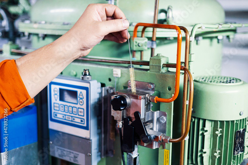 hands of mechanic inspect fuel equipment