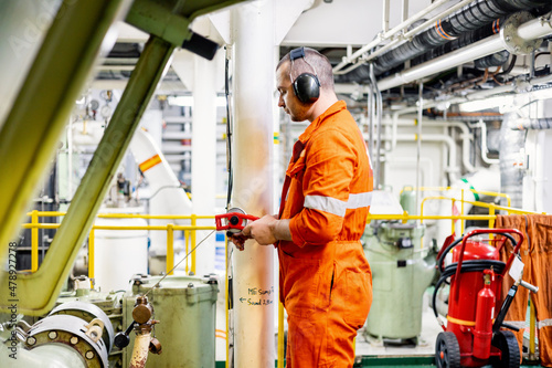 Marine engineer uses sounding tape