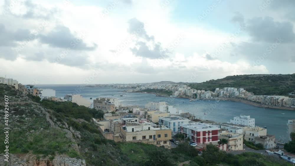 AERIAL: Mellieha Outskirts with Two Steep Hills Surrounding Bay in Winter AERIAL: Mellieha Outskirts with Two Steep Hills Surrounding Bay in Winter