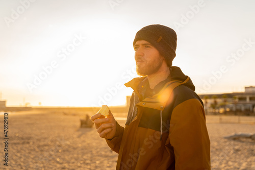 Portrait of pensive man at beach during sunset photo