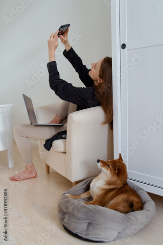 woman is sitting on a chair and talking video call photo