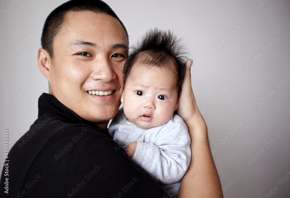 Closeup of newborn Asian baby and father Closeup of newborn Asian baby and father