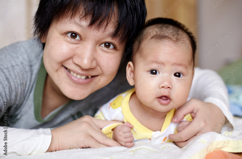 Closeup of newborn Asian baby and mom Closeup of newborn Asian baby and mom
