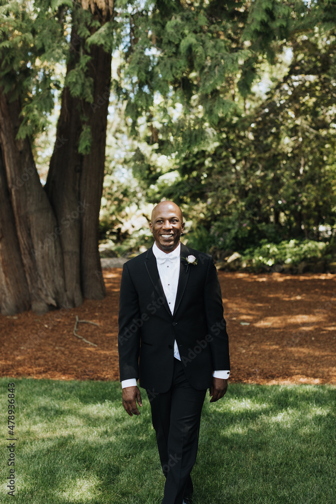 Happy Groom Walking in Woods Wearing a Tux Happy Groom Walking in Woods Wearing a Tux