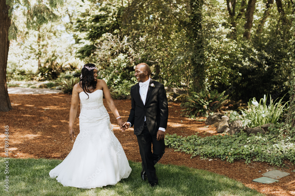 Smiling Bride and Groom Walking in Forest Smiling Bride and Groom Walking in Forest