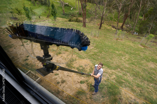 WIndow cleaner reaching high windows photo