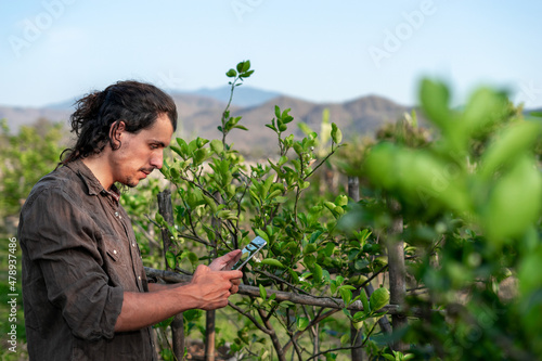 Smart Farmer man in farm study read or analysis data report in tablet computer on an agriculture field. High technology innovations for increasing productivity and owner of a small business concept