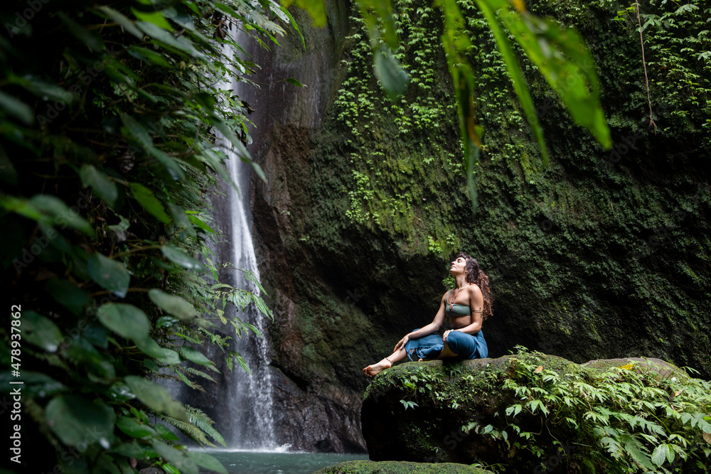 Woman Relaxing in front of Waterfall Woman Relaxing in front of Waterfall