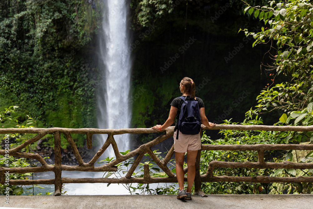 Hiker looking at Waterfall in Arenal Costa Rica Hiker looking at Waterfall in Arenal Costa Rica