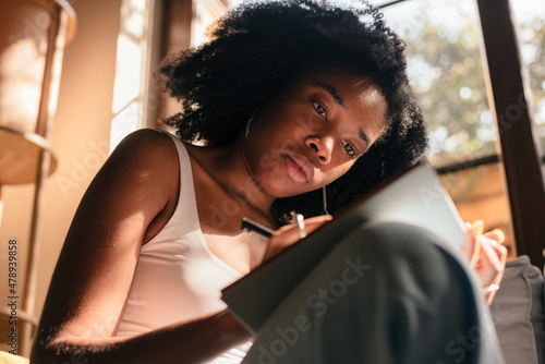 Inspired woman writing in a journal