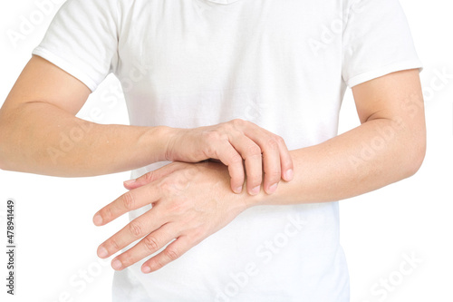 The man touches the wrist and thumb. He squeezes the knuckle of the thumb and wrist. He suffered a tendon injury, arthritis in his wrist, and de quervain's disease. © Photo Sesaon